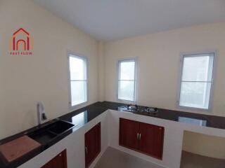 Modern kitchen with cabinetry and windows