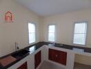 Modern kitchen with cabinetry and windows