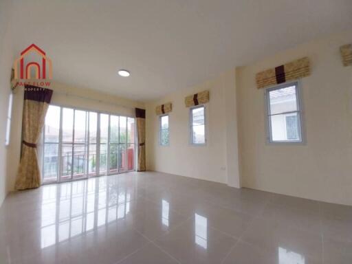 Spacious living room with large windows and balcony access