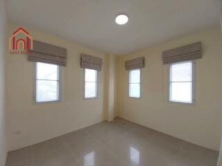 Bright and spacious bedroom with multiple windows