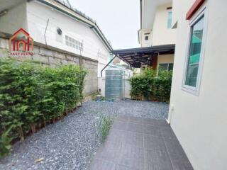 Outdoor area with gravel pathway and green plants