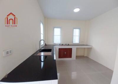 Modern kitchen with black countertop and white cabinets