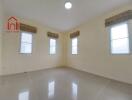 Spacious bedroom with tile flooring and multiple windows