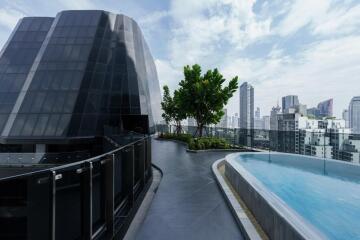 Modern building rooftop with a pool and city view