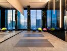 Modern gym with yoga mats and a stunning city view