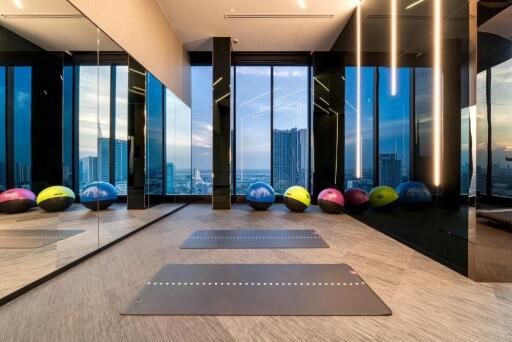 Modern gym with yoga mats and a stunning city view