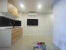 Modern kitchen area with wall-mounted TV