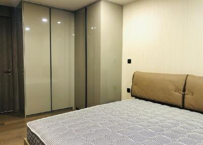 Modern bedroom with bed and large wardrobes