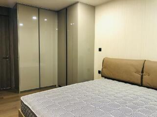 Modern bedroom with bed and large wardrobes