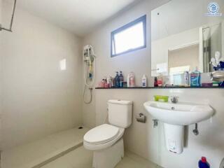 Modern bathroom with shower, sink, and toilet