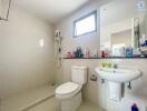 Modern bathroom with shower, sink, and toilet