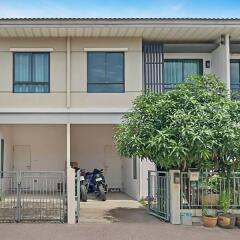 Two-story residential building with garage and front yard