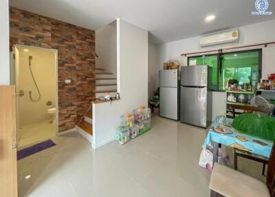 Modern kitchen view with appliances and adjacent shower room