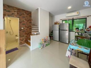 Modern kitchen view with appliances and adjacent shower room