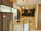 Modern kitchen with mosaic tiles and floating lights