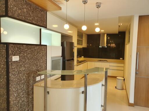 Modern kitchen with mosaic tiles and floating lights