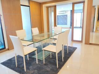 Modern dining room with glass table and white chairs