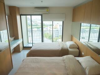 Modern bedroom with two beds and large windows