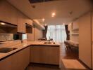 A modern kitchen with integrated living space and work area