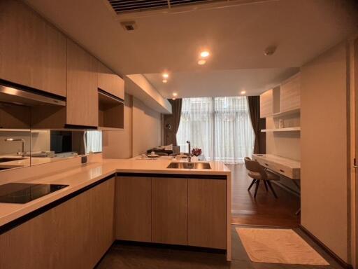 A modern kitchen with integrated living space and work area