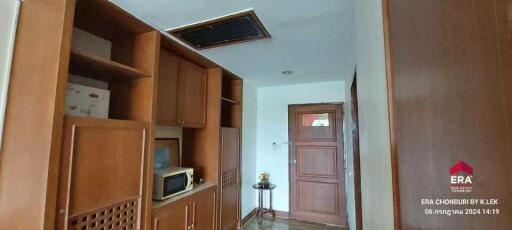 Hallway with wooden cabinets and door