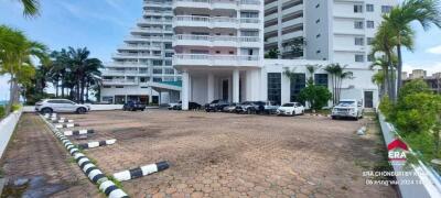 Exterior view of a modern residential building with parking area