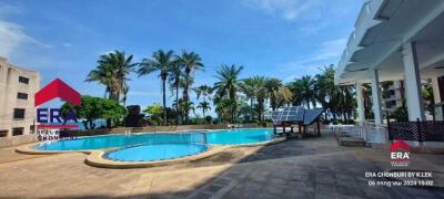 Outdoor pool area with seating and palm trees