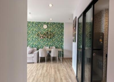 Modern living and dining area with green accent wall