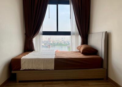 Small bedroom with a bed next to a window with view