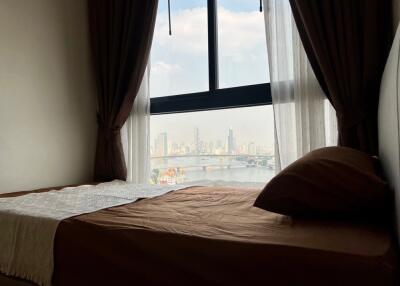 Bedroom with window view of city skyline
