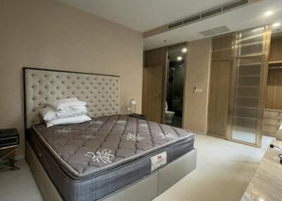 Bed with a tufted headboard in a spacious bedroom