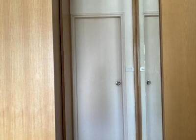 Hallway with wooden doors and mirrored wardrobes