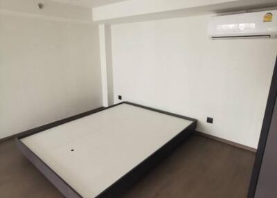 Minimalistic empty bedroom with bed frame and air conditioning