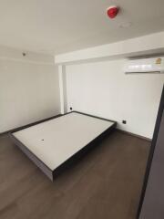 Minimalistic empty bedroom with bed frame and air conditioning