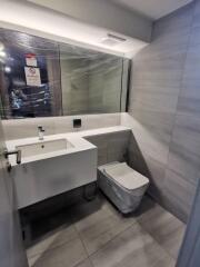 Modern bathroom with sink, mirror, and toilet