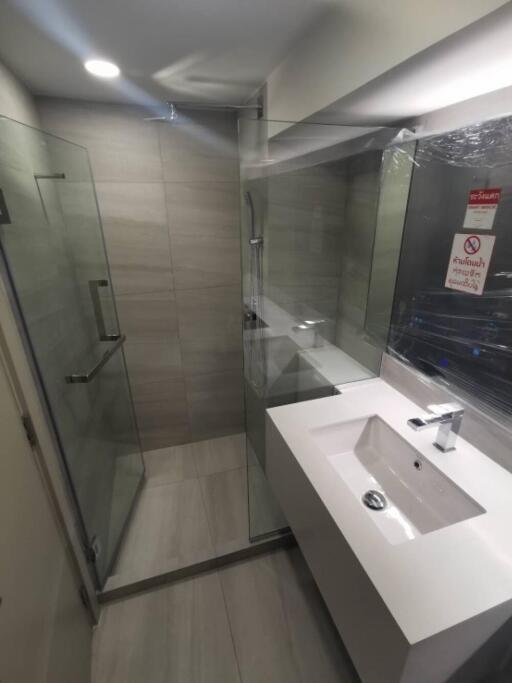 Modern bathroom with glass shower and white sink