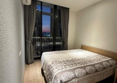 Modern bedroom with balcony and nighttime view