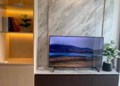 Living room with TV and shelving unit