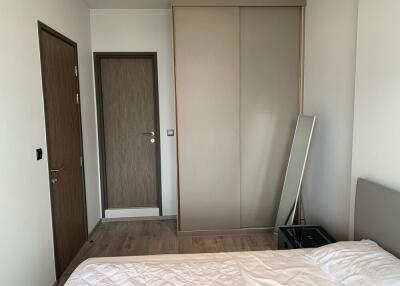 Simple bedroom with wooden doors and wardrobe