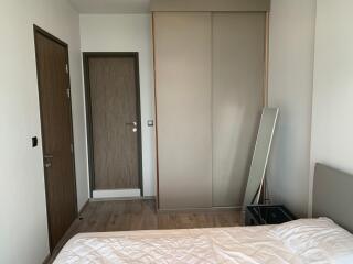 Simple bedroom with wooden doors and wardrobe