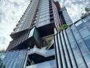 Modern high-rise apartment building with glass facades and balconies