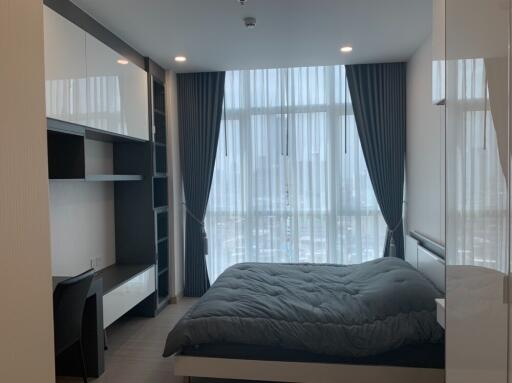 Modern bedroom with large window and shelving