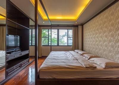 Modern bedroom with large windows and ceiling lights