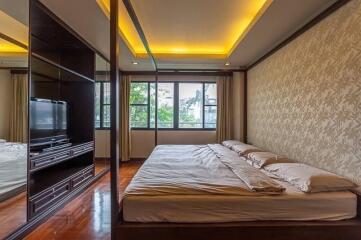 Modern bedroom with large windows and ceiling lights