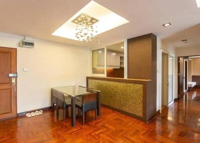 Modern dining area with hardwood floors and stylish lighting