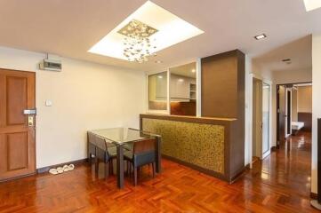 Modern dining area with hardwood floors and stylish lighting