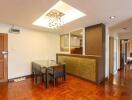 Modern dining area with hardwood floors and stylish lighting