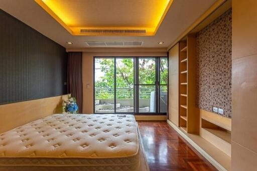 Spacious bedroom with large window and built-in storage