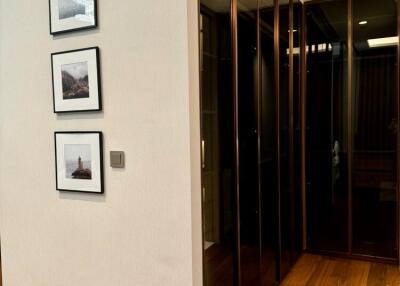 Modern hallway with glass cabinets and framed pictures on the wall