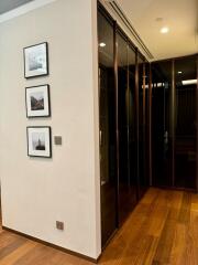 Modern hallway with glass cabinets and framed pictures on the wall